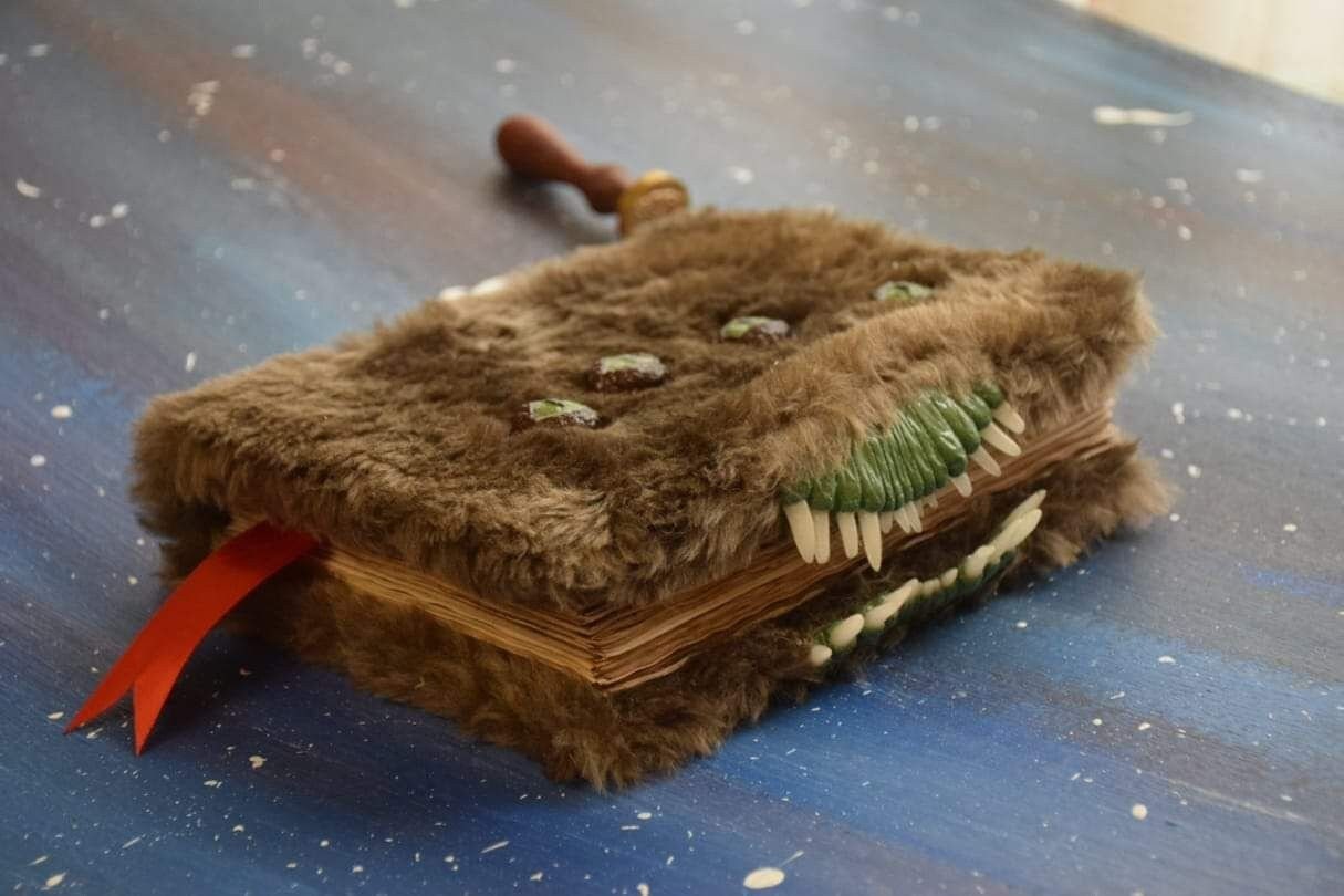 The Monster Book of Monsters with green eyes and teeth Replica